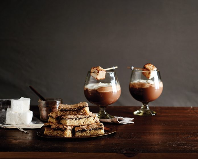 Dream Bars stacked on plate on wooden table