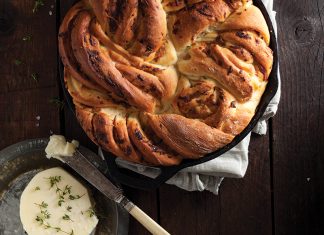Top 9 Recipes For Your Thanksgiving Bread Basket Onion Twist Bread in cast iron skillet on wood surface