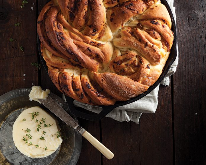 Onion Twist Bread in cast iron skillet on wood surface