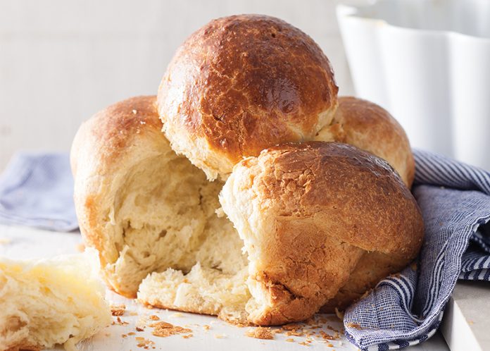 Brioche à Tête on white surface torn into baking recipe