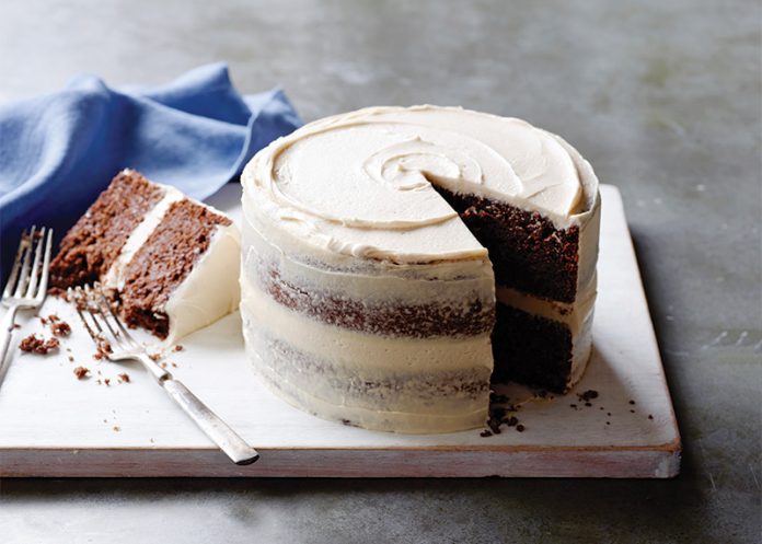 Cocoa-Stout Cake with Malted Buttercream on white marble sliced
