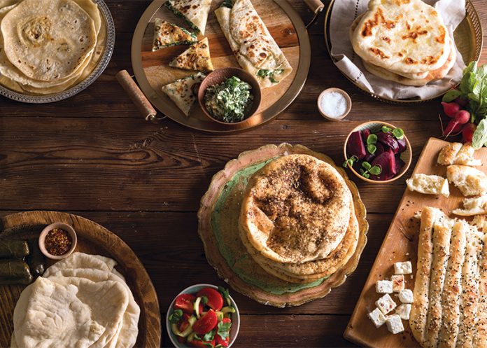 Spinach and Three Cheese Gözleme with other recipes on brown table