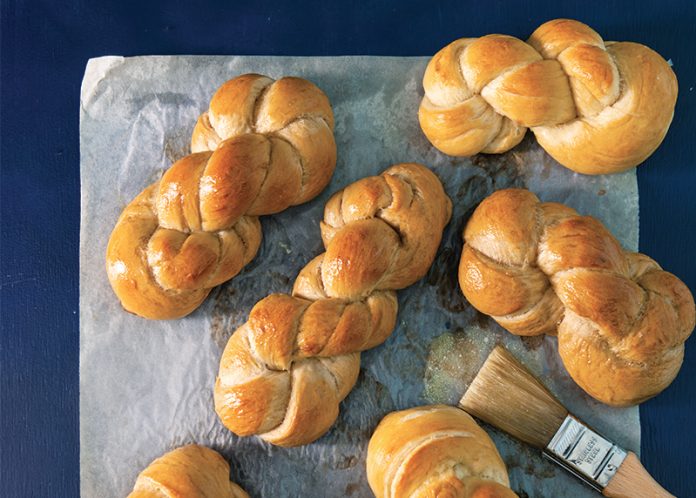 Pretzel Twists on parchment on blue surface baking recipe