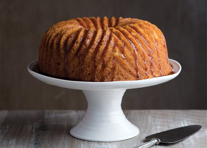 Rum-Soaked Pound Cake on white cake stand