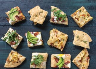 Four Ways with Focaccia Four ways with Focaccia sliced and topped on green surface