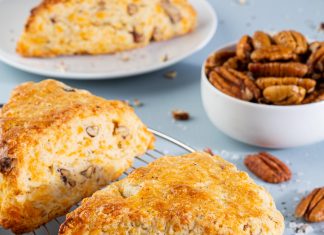 Black Pepper, Cheddar, and Pecan Scones Black Pepper, Cheddar, and Pecan Scones on wire rack on blue surface