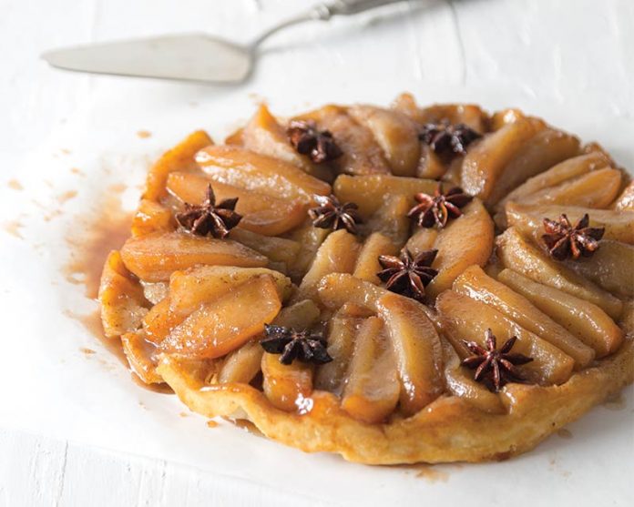 Tarte Tatin on white surface with star anise