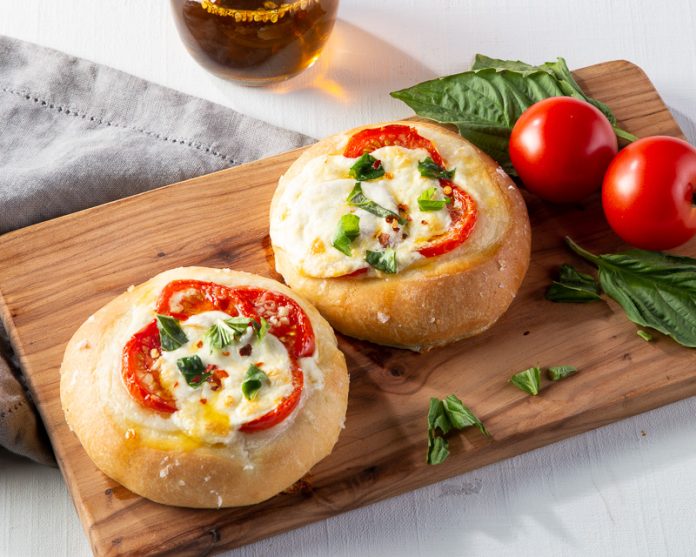 Tomato-Burrata Tarts on wooden board