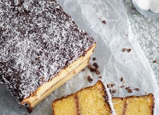 Orange-Plum Lamington Loaf Cake Orange-Plum Lamington Loaf Cake sliced on parchment