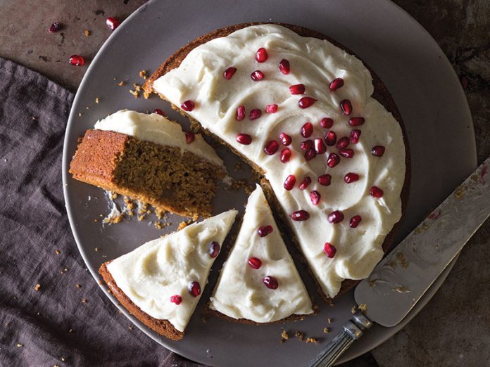 Pomegranate Molasses Gingerbread Cake sliced overhead on gray plate