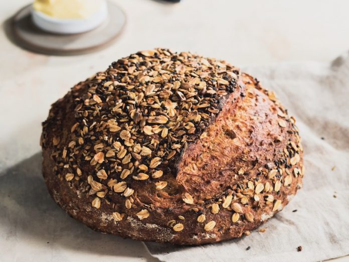 Multigrain Dutch Oven Bread whole on linen