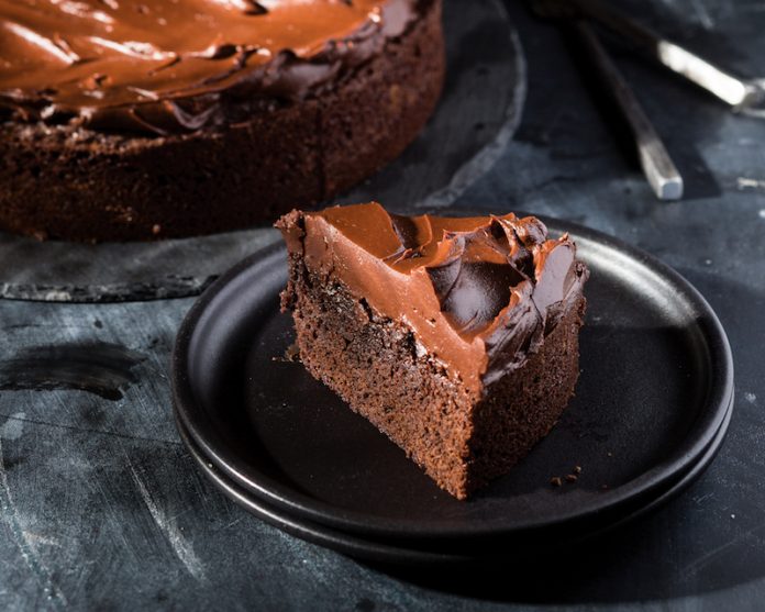 Chocolate Olive Oil Cake on black plate sliced