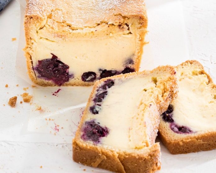 Gateau Basque Loaf sliced on white surface