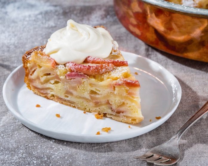 French Apple Cake on white plate on gray surface