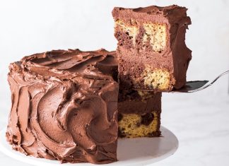 Peanut Butter-Chocolate Marble Cake Peanut Butter-Chocolate Marble Cake sliced lifting slice on white cake stand