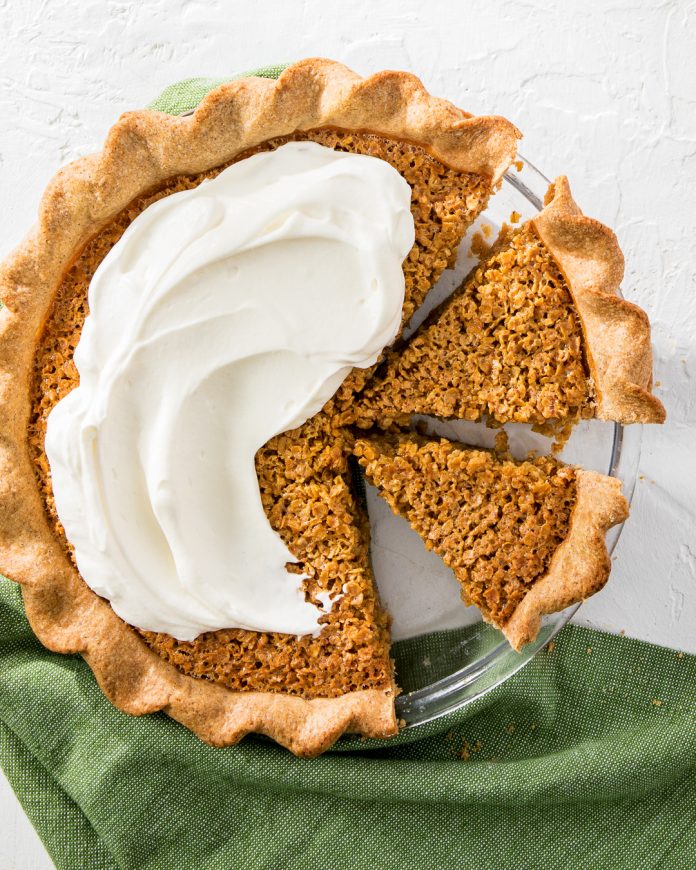 Spiced Honey-Oat Pie sliced in glass pie plate