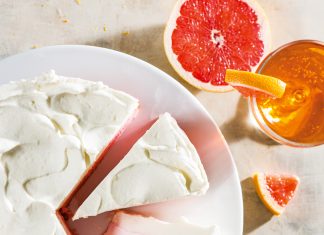 Layered Grapefruit Cake Layered Grapefruit Cake sliced on white plate