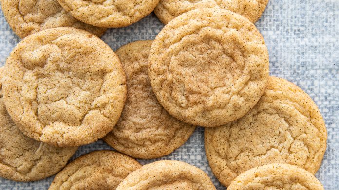 Snickerdoodles stacked on parchment