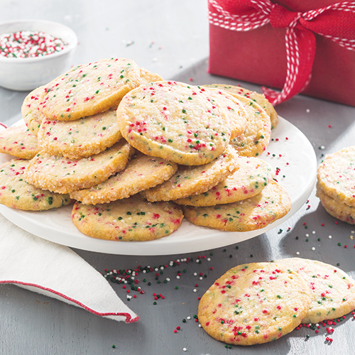 Cookies with sprinkles on white plate - Bake from Scratch
