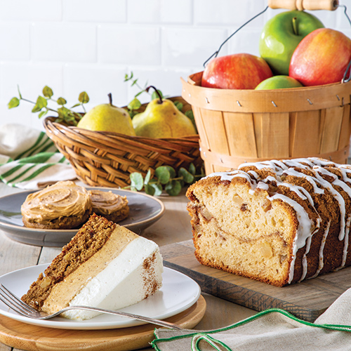 sliced cake with apple basket in background - Bake from Scratch