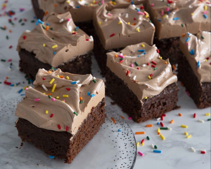 Chocolate Snack Cake sliced on glass plate on marble surface