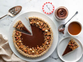 Hazelnut-Chocolate Tart chocolate hazelnut tart overhead sliced on white plate