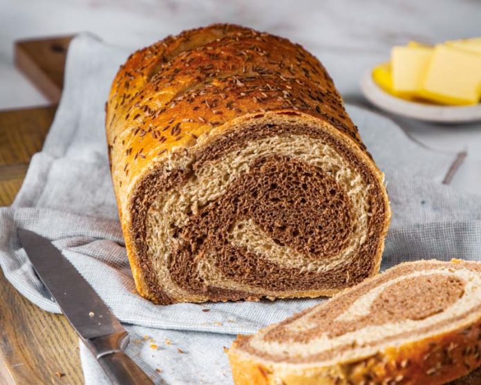 marbled rye bread on fabric with knife