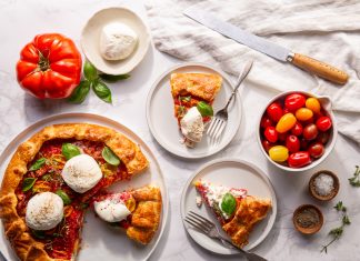 Three-Cheese Tomato Crostata visual representation of a Three Cheese & Tomato Crostata from Bake from Scratch. The crostata is skillfully crafted, with a golden, flaky crust embracing a rich filling of three cheeses and ripe tomatoes. The dish showcases a harmonious blend of textures and colors, inviting anticipation of a delicious culinary experience
