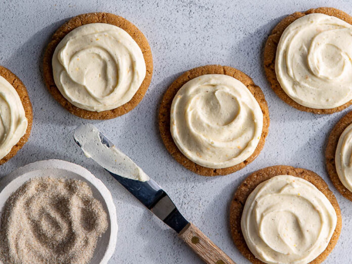 Vanilla Chai Spice Crinkle Cookies on blue surface with offset spatula and vanilla sugar