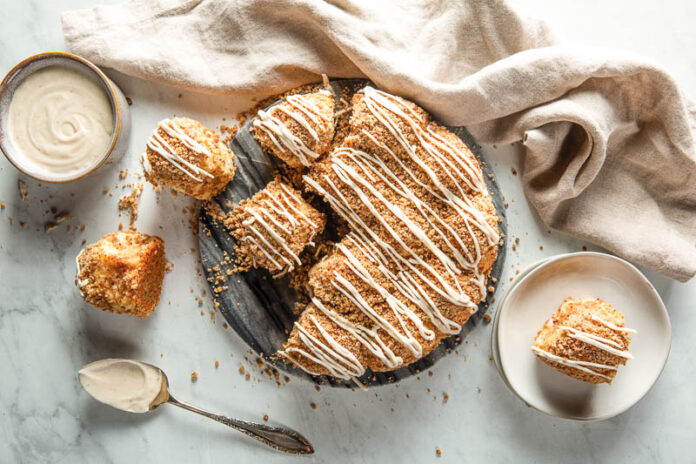 Hungarian coffee cake pulled apart overhead on marble.