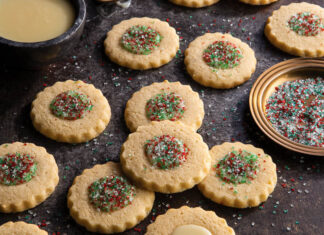Marzipan Thumbprint Cookies marzipan thumbprint cookies with sparkling sugars on dark surface.