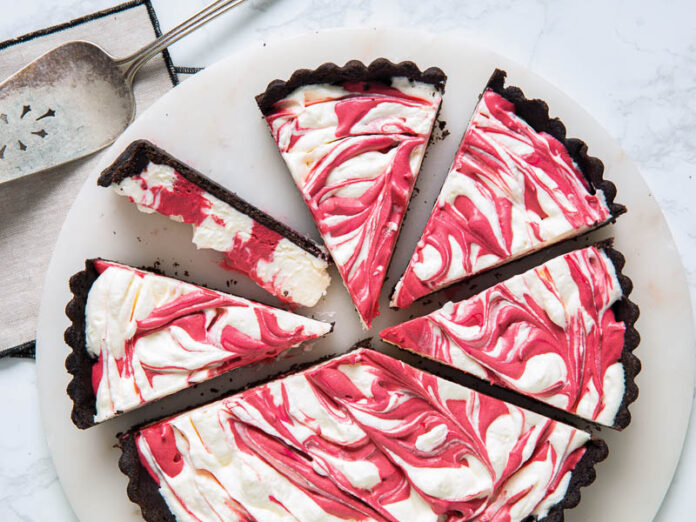 red velvet cheesecake tart sliced on marble