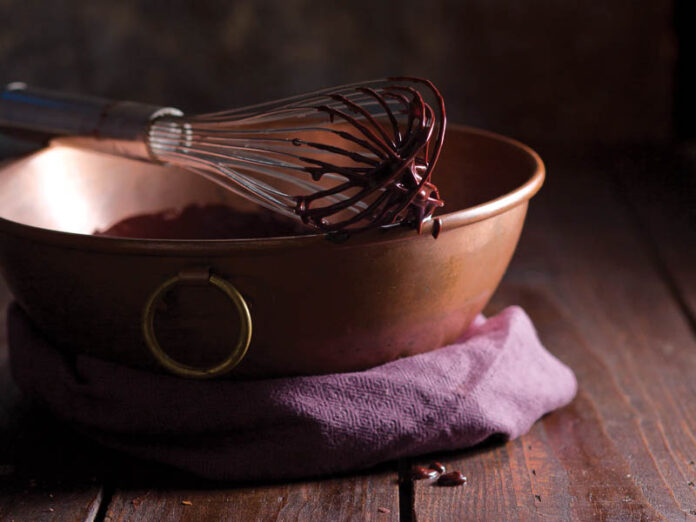 Whisk with Chocolate in Copper Pan on Purple Towel and Hardwood 5 Simple Chocolate Recipes for a Dreamy Valentine's Day