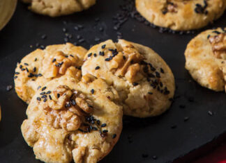 Walnut Cookies Walnut Cookies on Black Tray with Bowl of Sesame Seeds