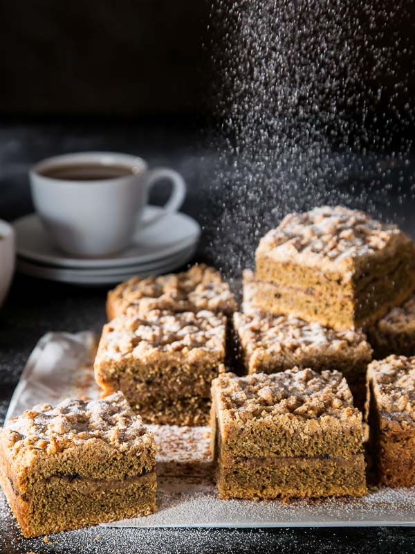 Irish Coffee Coffee Cake on parchment with cup of coffee