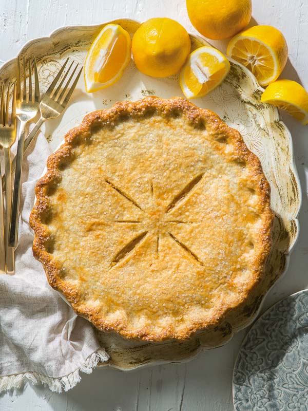 Meyer Lemon Shaker Pie on platter with forks and lemons